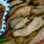 Strips of Chilean grilled beef udder on the barbecue, browned and crisp at the edges