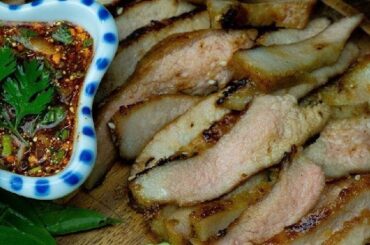Strips of Chilean grilled beef udder on the barbecue, browned and crisp at the edges