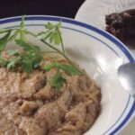Chilean guanaca served in a deep bowl, a mix of toasted flour and prietas broth, garnished with parsley.