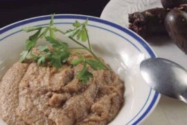 Chilean guanaca served in a deep bowl, a mix of toasted flour and prietas broth, garnished with parsley.