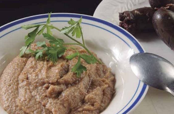 Chilean guanaca served in a deep bowl, a mix of toasted flour and prietas broth, garnished with parsley.