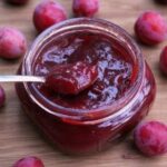 Chilean plum jam in glass jars, with dark red fruit
