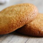 Homemade Chilean honey cookies, golden and baked, stacked on a plate.