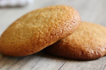 Homemade Chilean honey cookies, golden and baked, stacked on a plate.