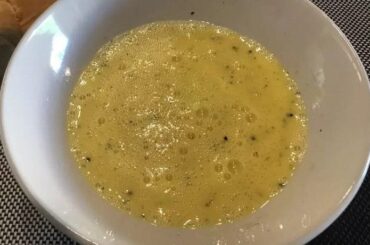 Chilean huevos a la ostra served in a bowl, a raw egg and lime mixture.
