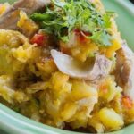 Chilean canned jack mackerel charquican with mashed potato and squash, topped with a fried egg