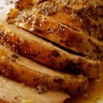 Juicy roast pork loin sliced and served with a reduced white wine and herb sauce