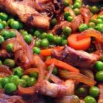Chilean lamb and pea stew, served hot in a clay dish.