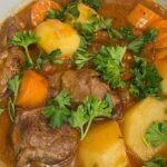 Magallanes lamb cazuela with potatoes, squash, and broth in a traditional clay pot