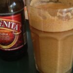 Large glass of Chilean malta con harina tostada, a cold energy drink made with dark beer and toasted flour.
