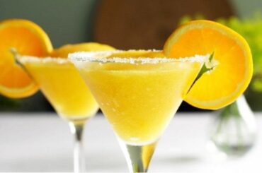 Chilean mango sour cocktail in a sugar-rimmed martini glass