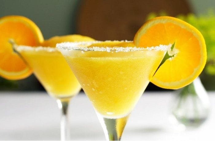 Chilean mango sour cocktail in a sugar-rimmed martini glass
