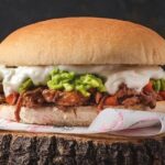 Chilean mechada italiana sandwich in marraqueta with tomato, avocado, and homemade mayonnaise
