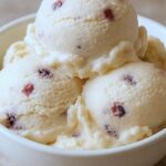 Scoops of homemade pink murta berry ice cream with fresh murtas