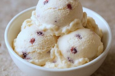 Scoops of homemade pink murta berry ice cream with fresh murtas