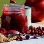 Homemade Chilean murta berry jam, served in a bowl with fresh murtas.