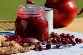 Homemade Chilean murta berry jam, served in a bowl with fresh murtas.
