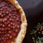 Chilean murta kuchen with a crisp shortcrust base filled with pastry cream and fresh murtilla berries