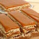 Chilean no-bake galletas de vino cake layered with manjar and topped with grated coconut