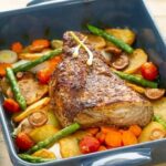 Chilean oven roast beef sliced with golden potatoes, onions, and red peppers