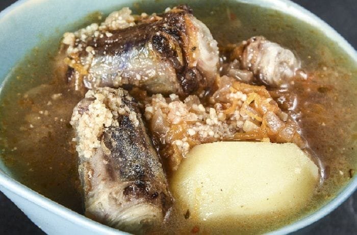 Chilean oxtail and cracked wheat soup with vegetables and whole potatoes