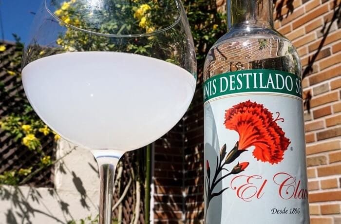 Chilean palomita blanca cocktail, dry anise and water turned milky white in a tall glass