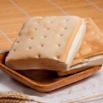Freshly baked Chilean pan coliza on a plate, showing its square shape and soft crumb.