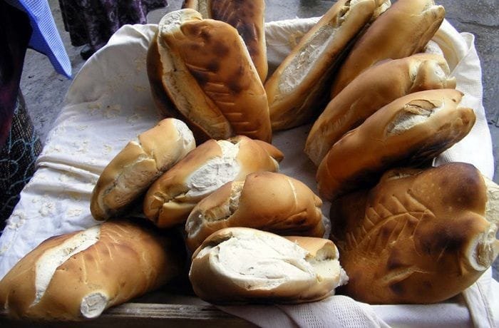 Chilean pan minero de Lota, kneaded bread with a golden crisp crust, served in a basket