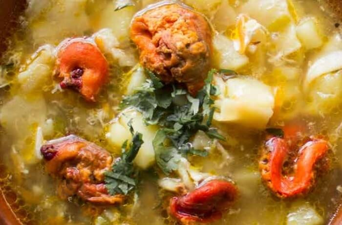 Chilean pancutras, flour dumplings in a broth with piures and vegetables