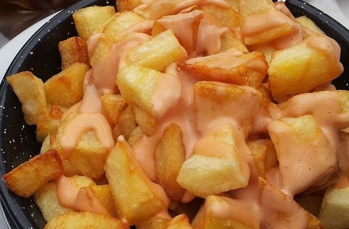 Chilean papas bravas, chopped and browned potatoes bathed in a creamy merken sauce.