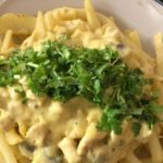 Chilean papas champi, fried potatoes topped with mushroom cream sauce and parmesan cheese.