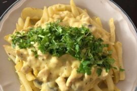 Chilean papas champi, fried potatoes topped with mushroom cream sauce and parmesan cheese.