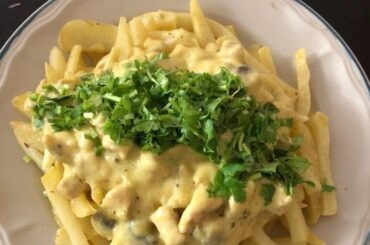 Chilean papas champi, fried potatoes topped with mushroom cream sauce and parmesan cheese.