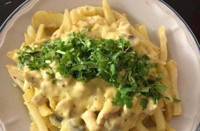 Chilean papas champi, fried potatoes topped with mushroom cream sauce and parmesan cheese.