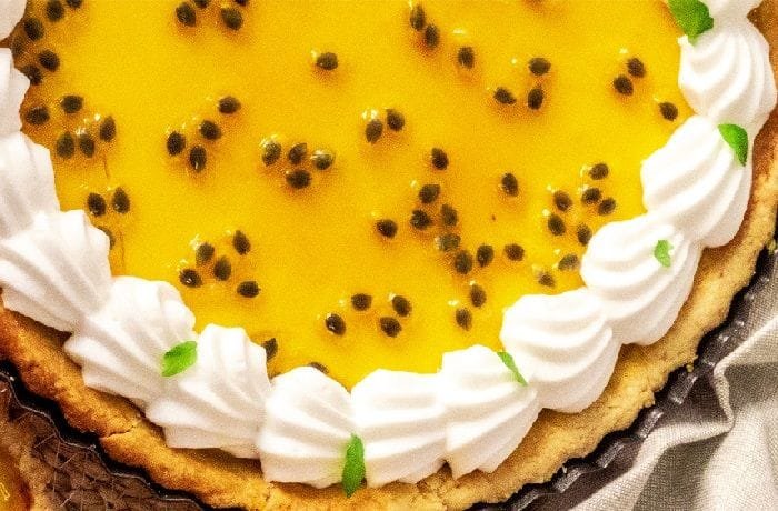 Chilled passion fruit pie with golden Italian meringue and passion fruit seeds