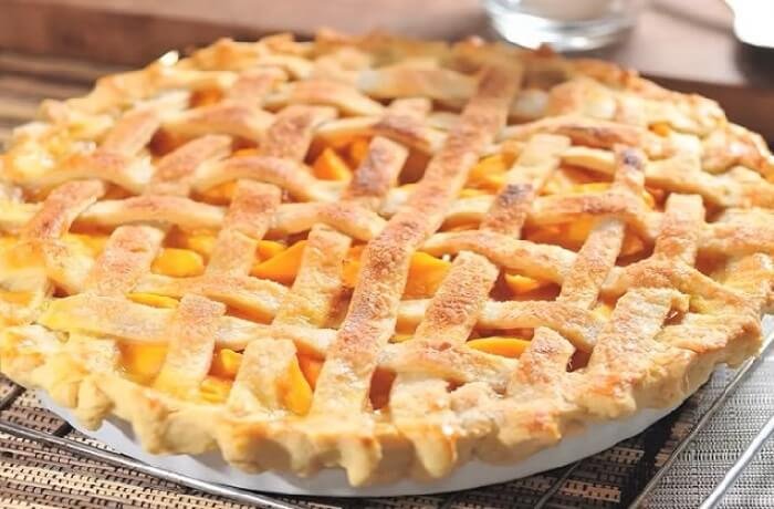 Freshly baked Chilean peach kuchen with pastry cream and golden peach slices