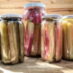 Chilean pickled nalca in a glass jar with garlic and pepper, ready to eat.