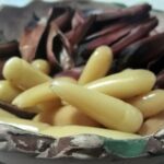 Chilean pine nuts in syrup, glossy and golden, served as a gourmet dessert topping.