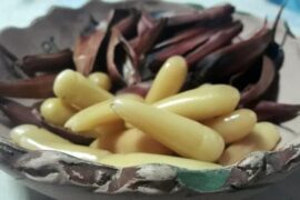Chilean pine nuts in syrup, glossy and golden, served as a gourmet dessert topping.