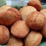 Golden Chilean sopaipillas made with araucaria pine nut flour, served in a traditional clay dish