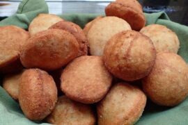 Golden Chilean sopaipillas made with araucaria pine nut flour, served in a traditional clay dish