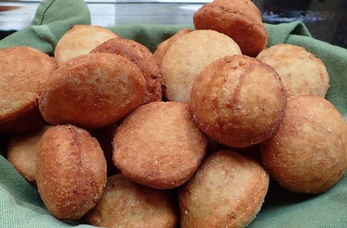Golden Chilean sopaipillas made with araucaria pine nut flour, served in a traditional clay dish
