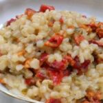 Creamy Chilean piure risotto topped with Parmesan, parsley, and crushed coriander seeds