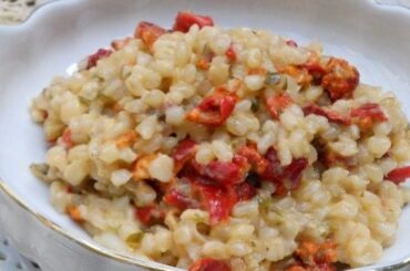 Creamy Chilean piure risotto topped with Parmesan, parsley, and crushed coriander seeds