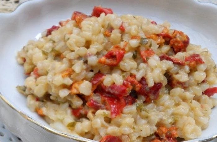 Creamy Chilean piure risotto topped with Parmesan, parsley, and crushed coriander seeds
