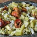 Chilean salad of red piures and olive-green ulte with onion, cilantro, and green chili