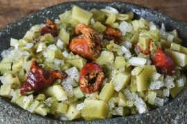 Chilean salad of red piures and olive-green ulte with onion, cilantro, and green chili