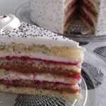 Chilean poppy seed cake layered with manjar, cream, and jam and topped with walnuts