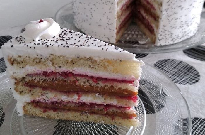 Chilean poppy seed cake layered with manjar, cream, and jam and topped with walnuts