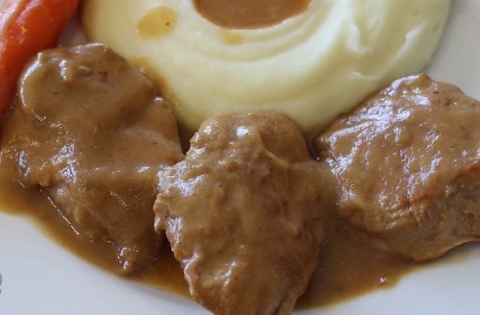 Chilean pork tenderloin braised in the pot, sliced into medallions with vegetable sauce and rice